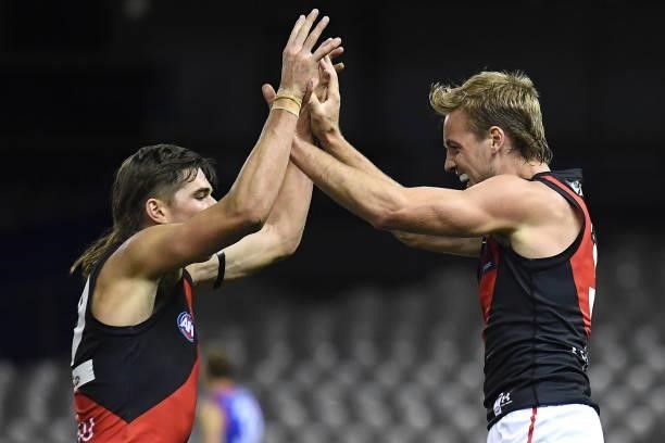 Darcy Parish of the Bombers is congratulated by Sam Durham after kicking a goal during the round 21 AFL match between Western Bulldogs and Essendon...