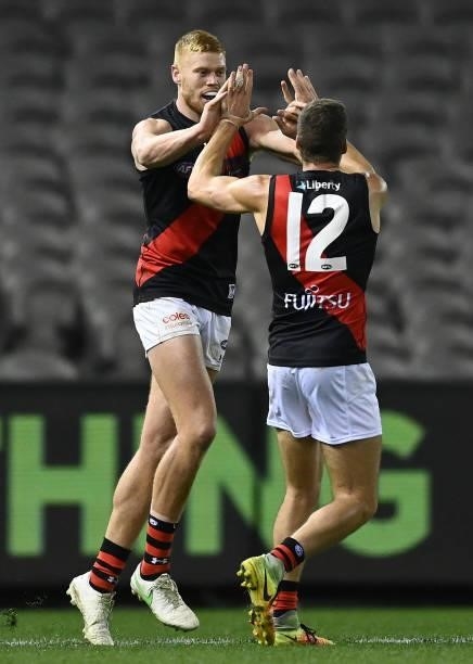 Peter Wright of the Bombers is congratulated by Tom Cutler after kicking a goal during the round 21 AFL match between Western Bulldogs and Essendon...