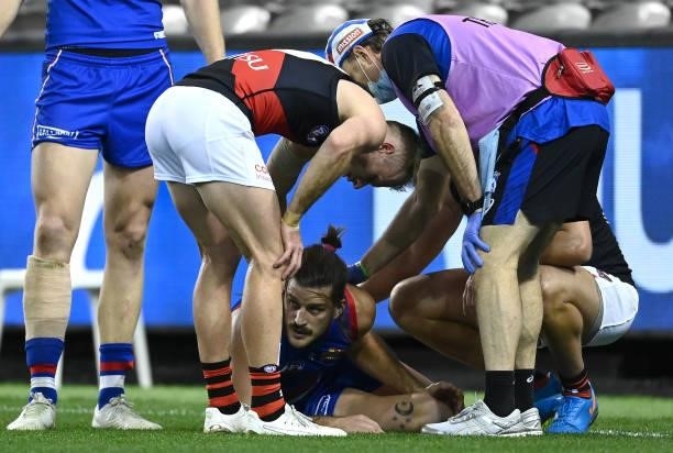 Josh Bruce of the Bulldogs grabs at his knee during the round 21 AFL match between Western Bulldogs and Essendon Bombers at Marvel Stadium on August...