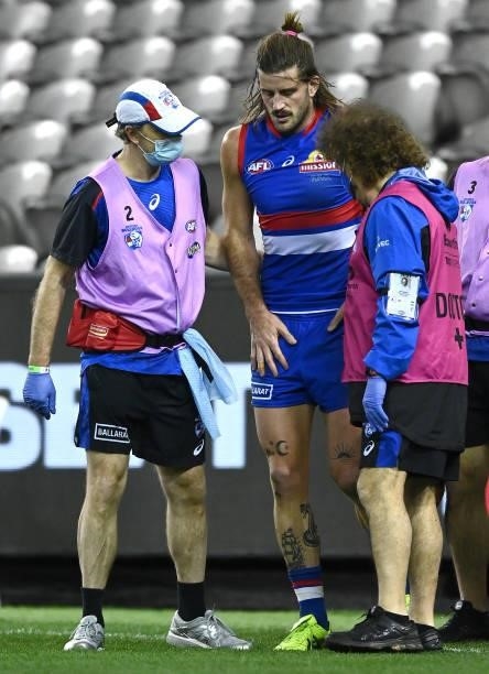 Josh Bruce of the Bulldogs is helped by trainers after hurting his knee during the round 21 AFL match between Western Bulldogs and Essendon Bombers...
