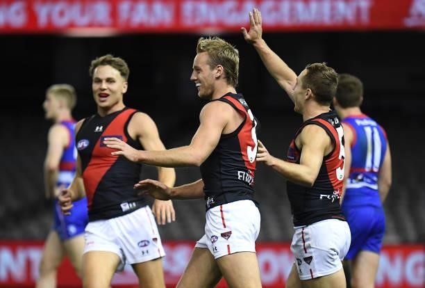 Darcy Parish of the Bombers is congratulated by team mates after kicking a goal during the round 21 AFL match between Western Bulldogs and Essendon...