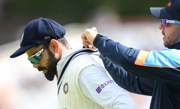 India captain Virat Kohli has a performance monitor fitted during day four of the First Test Match between England and India at Trent Bridge on...