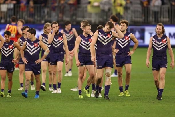 The Dockers walk from the field after being defeated during the round 21 AFL match between Fremantle Dockers and Brisbane Lions at Optus Stadium on...