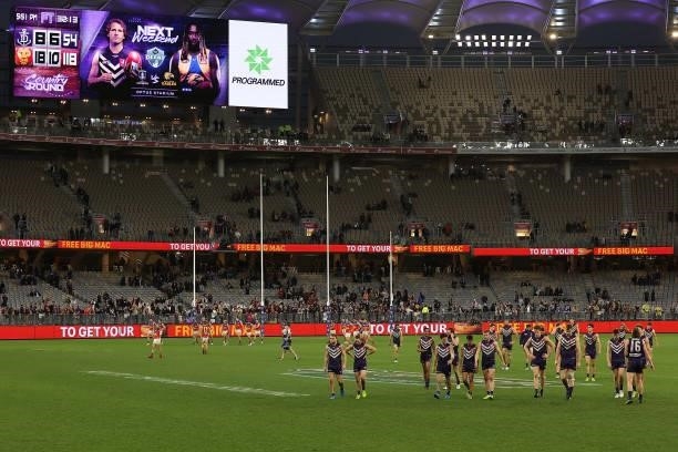 The Dockers walk from the field after being defeated during the round 21 AFL match between Fremantle Dockers and Brisbane Lions at Optus Stadium on...