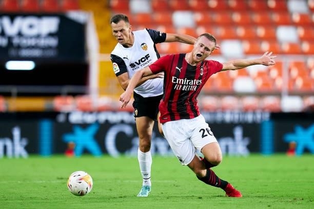 Denis Cheryshev of Valencia CF competes for the ball with Tommaso Pobega of AC Milan during a pre-season friendly match between Valencia CF and AC...