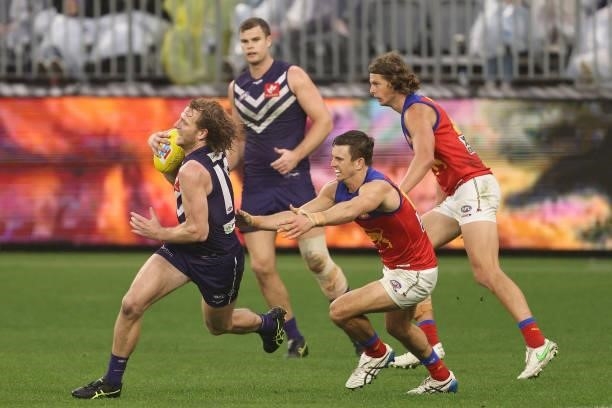 David Mundy of the Dockers looks to break from Jarryd Lyons of the Lions during the round 21 AFL match between Fremantle Dockers and Brisbane Lions...
