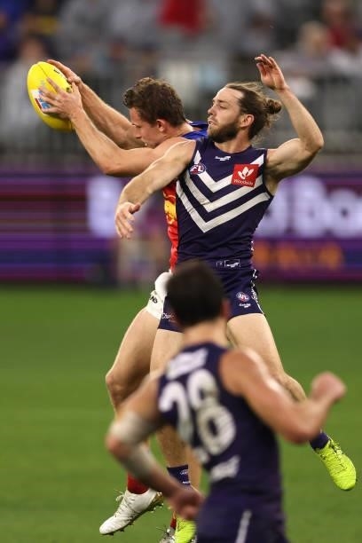 Ryan Lester of the Lions marks the ball against Travis Colyer of the Dockers during the round 21 AFL match between Fremantle Dockers and Brisbane...