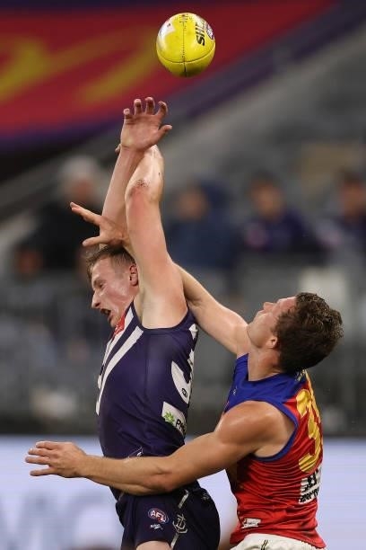 Josh Treacy of the Dockers and Ryan Lester of the Lions contest for a mark during the round 21 AFL match between Fremantle Dockers and Brisbane Lions...