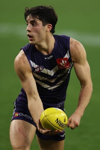 Adam Cerra of the Dockers looks to handball during the round 21 AFL match between Fremantle Dockers and Brisbane Lions at Optus Stadium on August 08,...