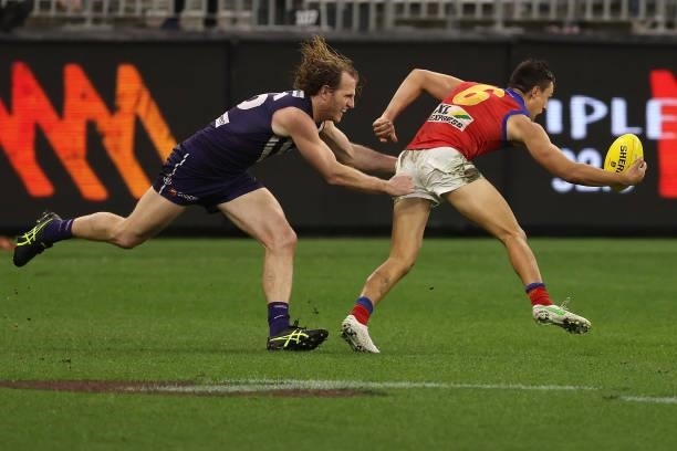 David Mundy of the Dockers tackles Hugh McCluggage of the Lions during the round 21 AFL match between Fremantle Dockers and Brisbane Lions at Optus...