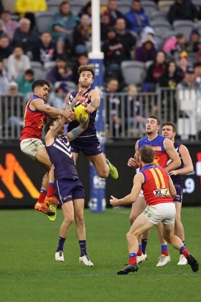 Charlie Cameron of the Lions contests for a mark against Nathan Wilson and Griffin Logue of the Dockers during the round 21 AFL match between...