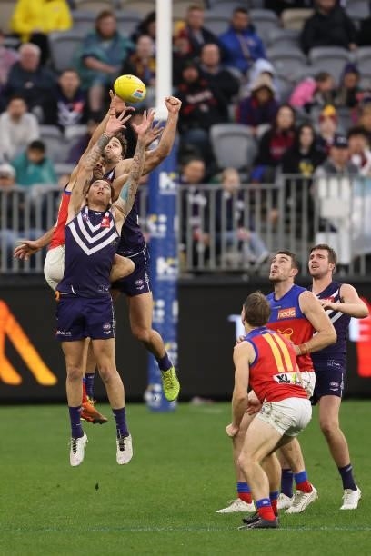 Charlie Cameron of the Lions contests for a mark against Nathan Wilson and Griffin Logue of the Dockers during the round 21 AFL match between...