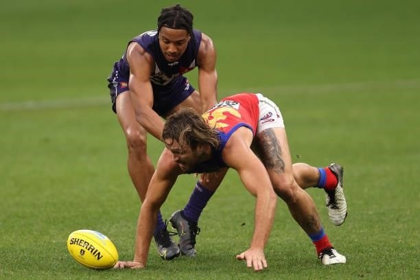Brandon Walker of the Dockers and Rhys Mathieson of the Lions contest for the ball during the round 21 AFL match between Fremantle Dockers and...