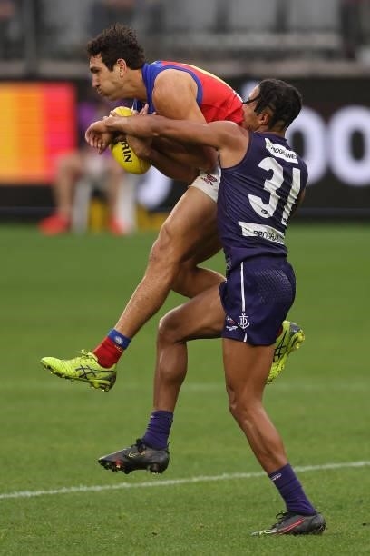 Nakia Cockatoo of the Lions marks the ball against Brandon Walker of the Dockers during the round 21 AFL match between Fremantle Dockers and Brisbane...