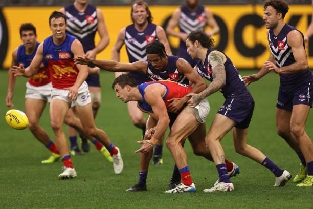 Jarryd Lyons of the Lions handballs during the round 21 AFL match between Fremantle Dockers and Brisbane Lions at Optus Stadium on August 08, 2021 in...