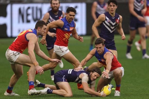 James Aish of the Dockers contests for the ball against Jarryd Lyons of the Lions during the round 21 AFL match between Fremantle Dockers and...