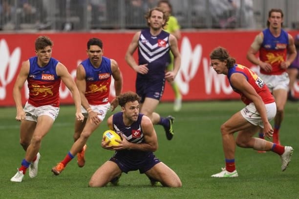 Griffin Logue of the Dockers looks to pass the ball during the round 21 AFL match between Fremantle Dockers and Brisbane Lions at Optus Stadium on...