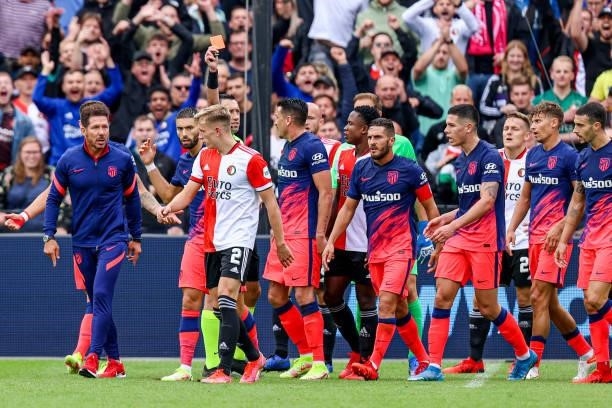 Referee Dennis Higler shows red card to Yannick Carrasco of Atletico Madrid after a conflict between players of Feyenoord and Atletico Madrid during...