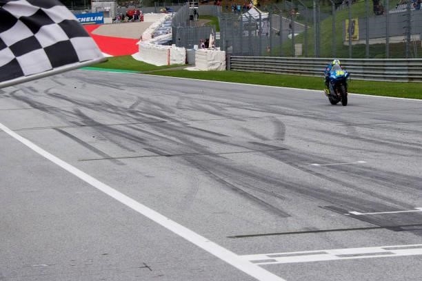 Joan Mir of Spain and Team Suzuki ECSTAR cuts the finish lane and celebrates the second place at the end of the MotoGP race during the MotoGP of...