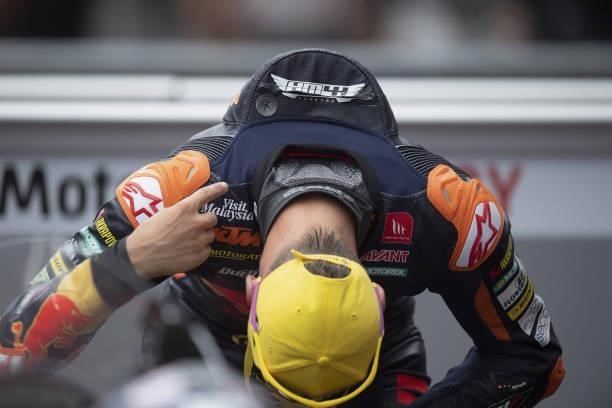 Pedro Acosta of Spain and Red Bull KTM Ajo celebrates the victory under the podium and shows the part of his leather in memory of the young rider...
