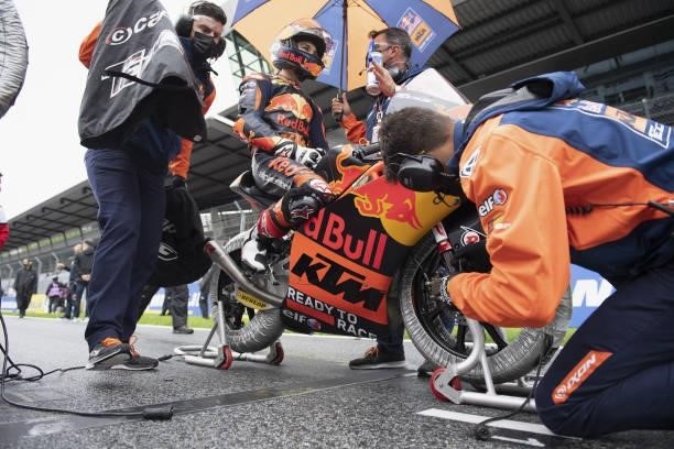 Deniz Oncu of Turkie and Red Bull KTM Tech3 prepares to start with mechanics on the grid during the Moto3 race during the MotoGP of Styria - Race at...