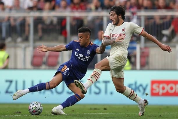 Sandro Tonali of AC Milan closes in on Mariano Diaz of Real Madrid as he lines up a shot on goal during the Pre-season friendly match between Real...