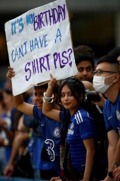 Fans hold up a sign during the Pre-Season Friendly match between Chelsea and Tottenham Hotspur at Stamford Bridge on August 04, 2021 in London,...