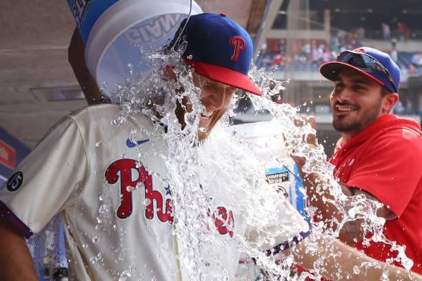 Pitcher Zack Wheeler of the Philadelphia Phillies is doused with water by Zach Eflin after pitching a two-hit complete game shutout against the New...