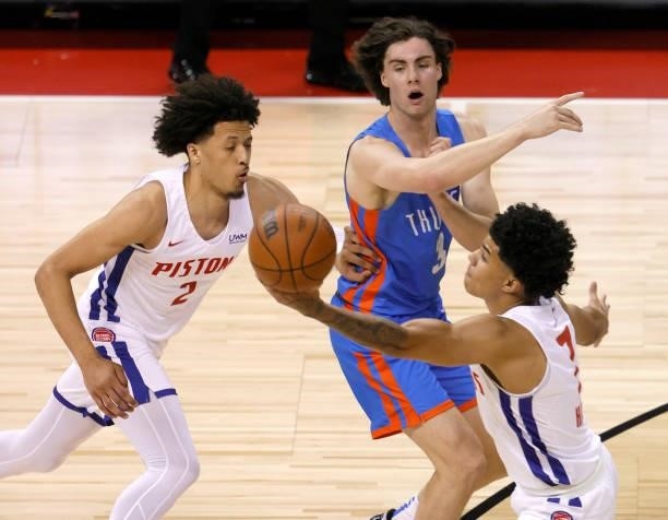 Josh Giddey of the Oklahoma City Thunder passes against Cade Cunningham and Killian Hayes of the Detroit Pistons during the 2021 NBA Summer League at...