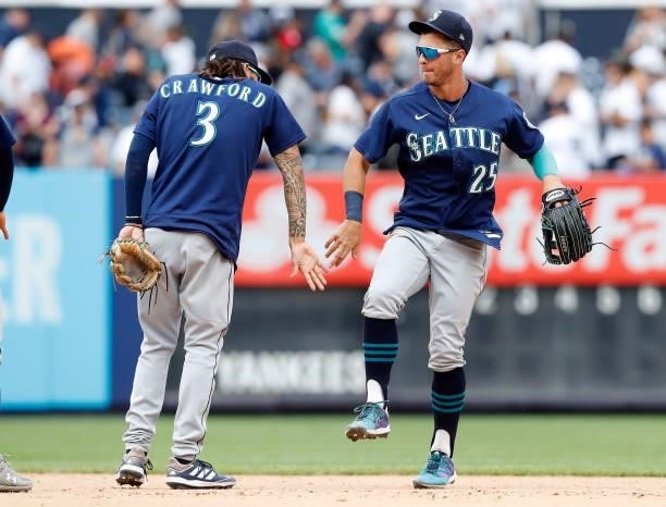 Dylan Moore and J.P. Crawford of the Seattle Mariners celebrate after defeating the New York Yankees at Yankee Stadium on August 08, 2021 in New York...