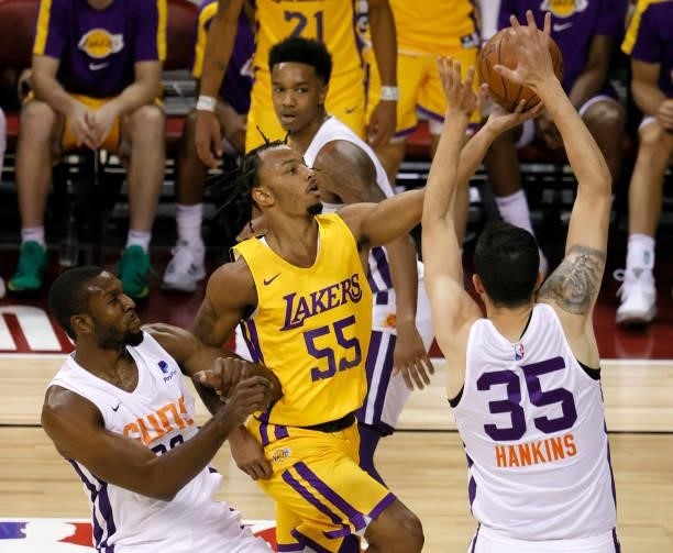 Justin Robinson of the Los Angeles Lakers drives to the basket against Vitto Brown and Zachary Hankins of the Phoenix Suns during the 2021 NBA Summer...