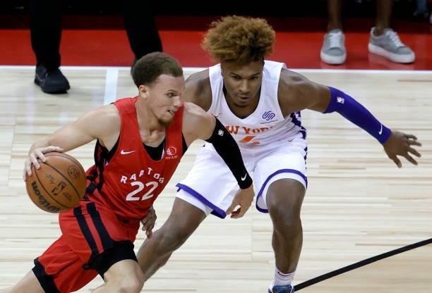 Malachi Flynn of the Toronto Raptors drives against Miles McBride of the New York Knicks during the 2021 NBA Summer League at the Thomas & Mack...