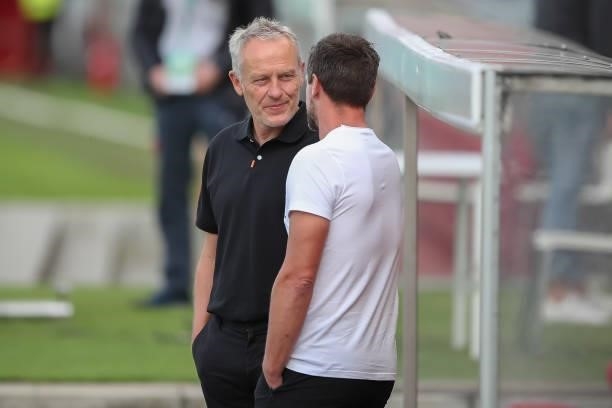 Christian Streich, Head coach of SC Freiburg talks to Torsten Ziegner, Head coach of Wuerzburger Kickers prior to the DFB Cup first round match...