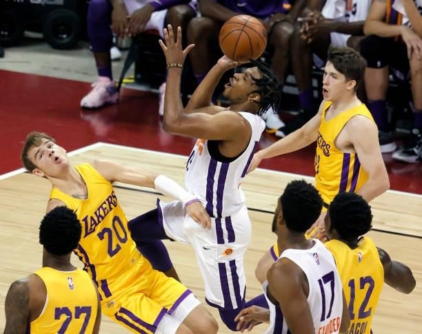 Justin Simon of the Phoenix Suns drives to the basket against Mac McClung and Austin Reaves of the Los Angeles Lakers during the 2021 NBA Summer...