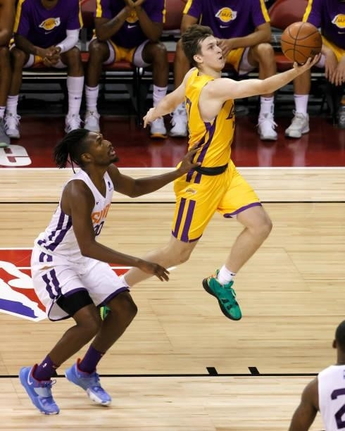 Austin Reaves of the Los Angeles Lakers drives to the basket against Jaleen Smith of the Phoenix Suns during the 2021 NBA Summer League at the Thomas...
