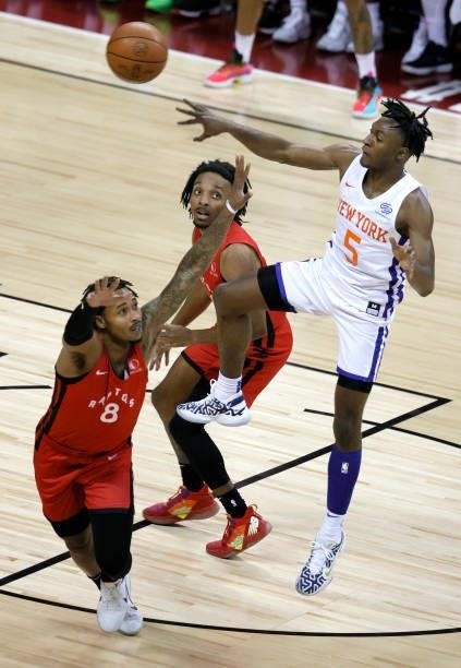 Immanuel Quickley of the New York Knicks passes against Jalen Adams and Matt Morgan of the Toronto Raptors during the 2021 NBA Summer League at the...