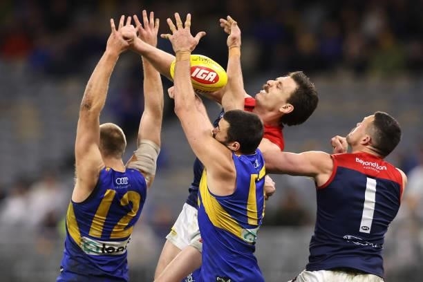 Jake Lever of the Demons contests a mark against Oscar Allen and Josh J. Kennedy of the Eagles during the round 21 AFL match between West Coast...