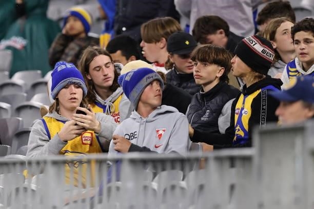 Spectators look on after play was suspended following lightning in the area during the round 21 AFL match between West Coast Eagles and Melbourne...