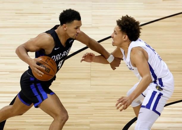 Jalen Suggs of the Orlando Magic brings the ball up the court against Colbey Ross of the Golden State Warriors during the 2021 NBA Summer League at...