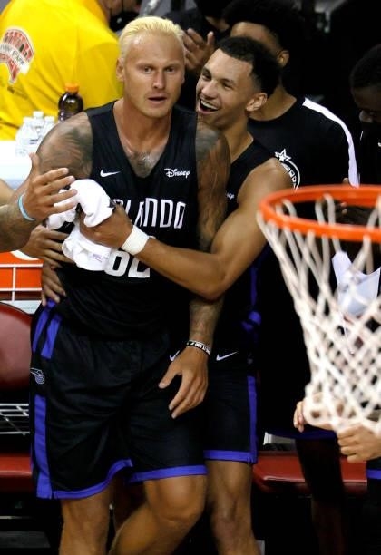 Janis Timma of the Orlando Magic backs into the bench as teammate Jalen Suggs hugs him during their game against the Golden State Warriors during the...