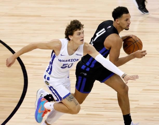Jalen Suggs of the Orlando Magic brings the ball up the court against Kyle Guy of the Golden State Warriors during the 2021 NBA Summer League at the...