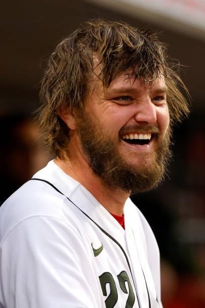 Wade Miley of the Cincinnati Reds talks with teammates in the dugout during the game against the Pittsburgh Pirates at Great American Ball Park on...