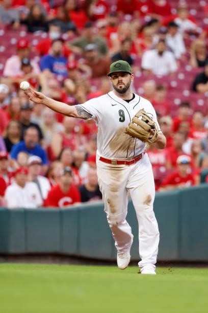 Mike Moustakas of the Cincinnati Reds throws the ball to first base during the game against the Pittsburgh Pirates at Great American Ball Park on...