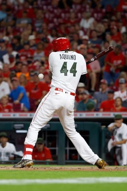 Aristides Aquino of the Cincinnati Reds is hit by a ball during the game against the Pittsburgh Pirates at Great American Ball Park on August 6, 2021...