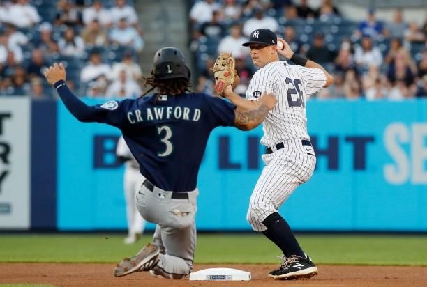 LeMahieu of the New York Yankees in action against J.P. Crawford of the Seattle Mariners at Yankee Stadium on August 05, 2021 in New York City. The...