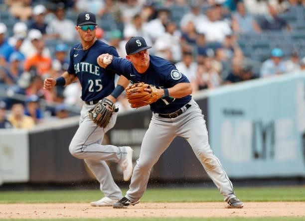 Kyle Seager and Dylan Moore of the Seattle Mariners in action against the New York Yankees at Yankee Stadium on August 07, 2021 in New York City. The...
