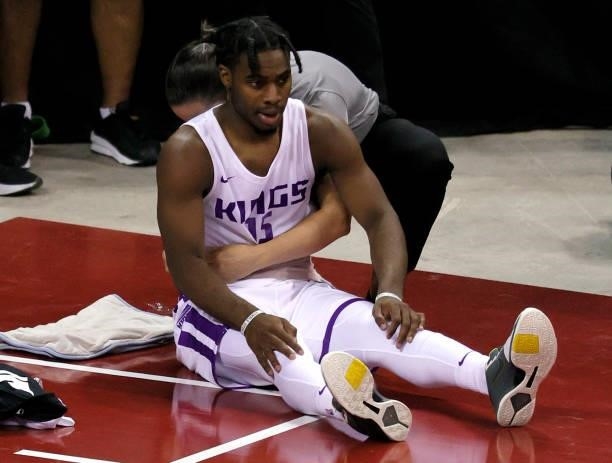 Davion Mitchell of the Sacramento Kings receives treatment on the sideline before checking back into a game against the Charlotte Hornets during the...