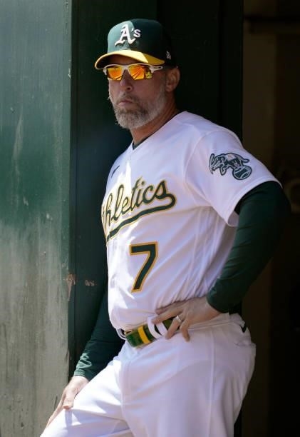 Third base coach Mark Kotsay of the Oakland Athletics looks on from the dugout against the San Diego Padres in the top of the first inning at...