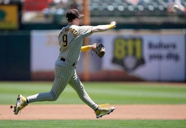 Jake Cronenworth of the San Diego Padres throws to first base throwing out Sean Murphy of the Oakland Athletics in the bottom of the second inning at...