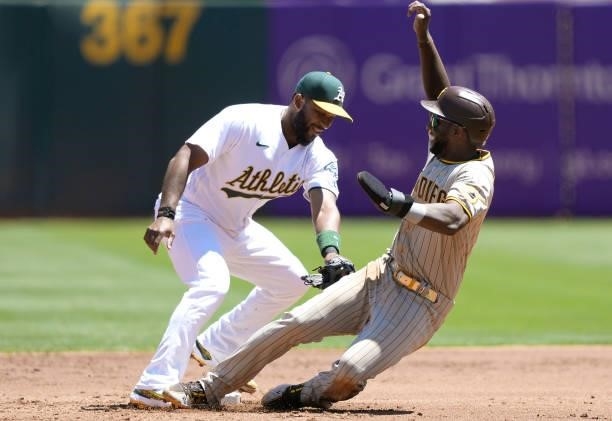 Jurickson Profar of the San Diego Padres attempting to steal second base gets tagged out by Elvis Andrus of the Oakland Athletics in the top of the...